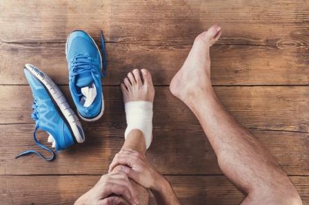 man's bandaged foot and running shoes portray the type of podiatry services we provide at Trevor Lane Podiatry