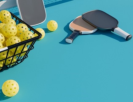 pickleball paddles and balls on blue background